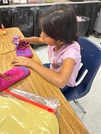 one girl painting painting moccasins